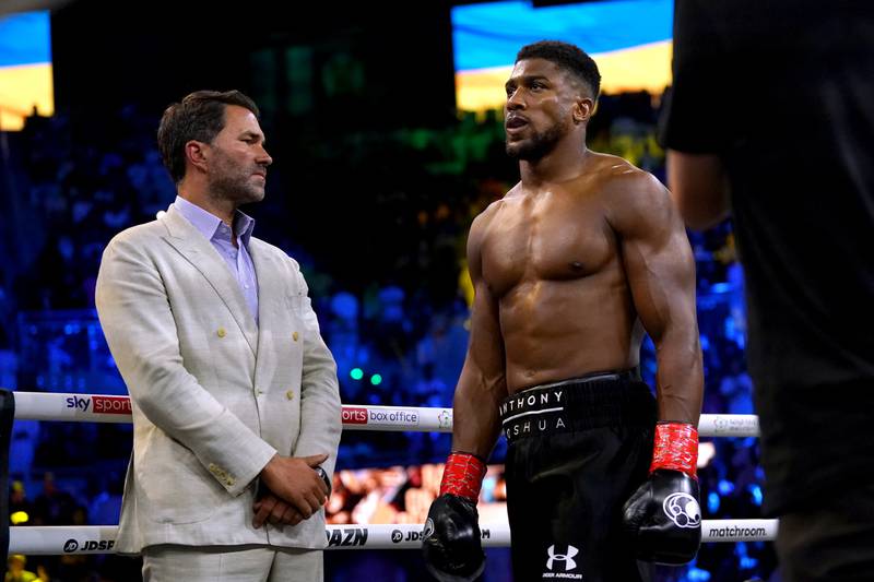 Anthony Joshua (right) and boxing promoter Eddie Hearn during the Ukrainian national anthem, prior to the World Heavyweight Championship WBA Super IBF, IBO and WBO fight against Oleksandr Usyk at the King Abdullah Sport City Stadium in Jeddah, Saudi Arabia. Picture date: Saturday August 20, 2022.