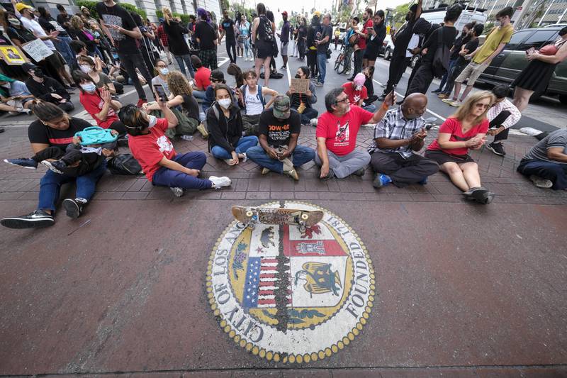 Protesters outside City Hall during the Los Angeles Council meeting on Tuesday. AP