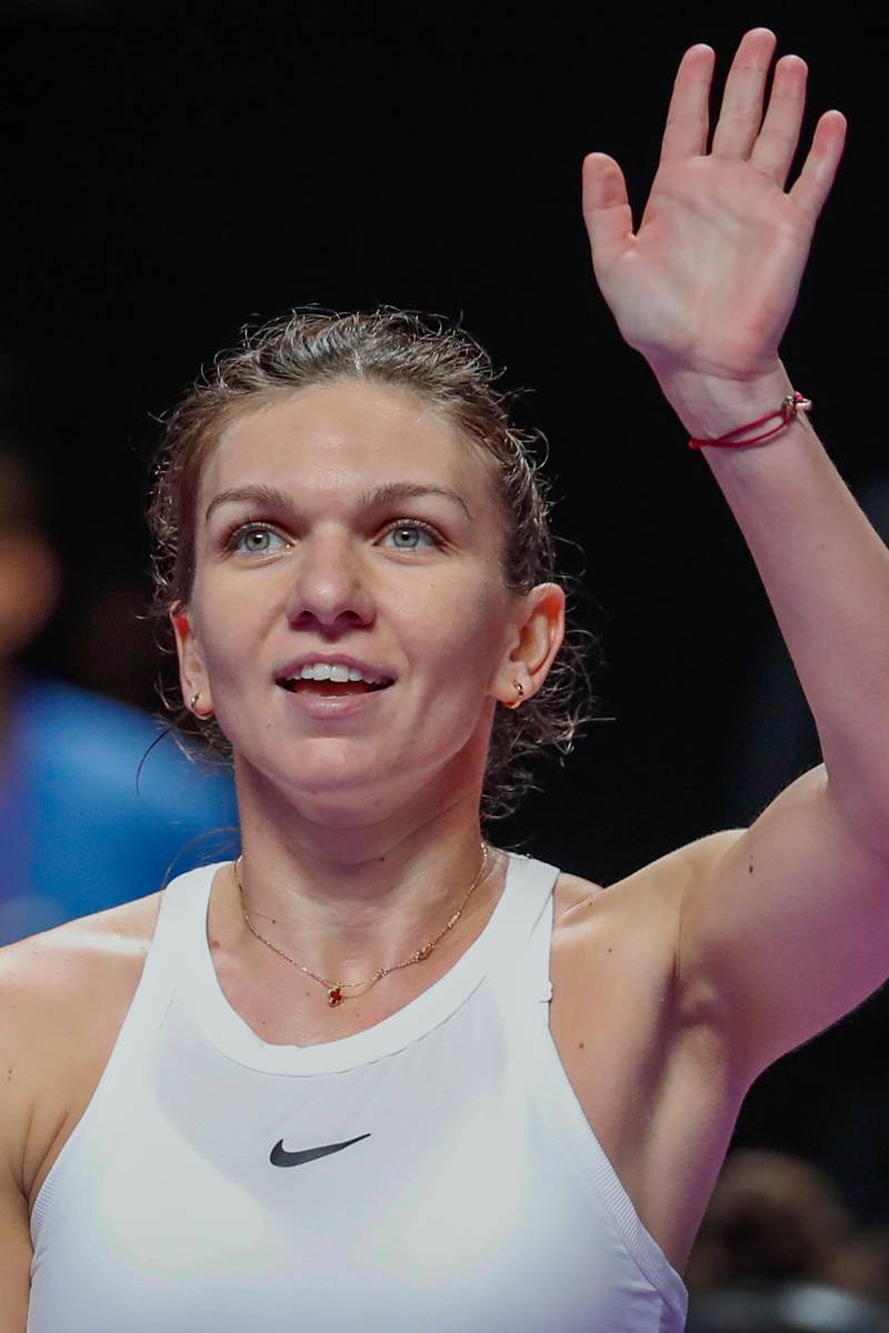 Simona Halep waves to the spectators after defeating Bianca Andreescu of Canada in their WTA Finals in Shenzhen on Monday. AP