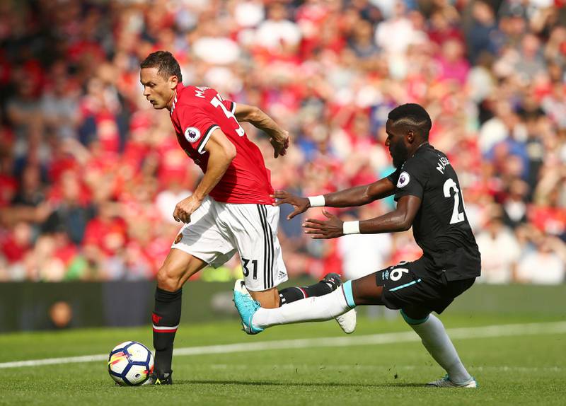 Manchester United's Nemanja Matic, left, gets past West Ham United's Arthur Masuaku during the English Premier League soccer match between Manchester United and West Ham United at Old Trafford in Manchester, England, Sunday, Aug. 13, 2017. (AP Photo/Dave Thompson)