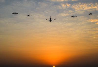 US Air Force A-10 'Warthogs' fly in formation flanking a larger aircraft, during operations over the Arabian Gulf. AFP