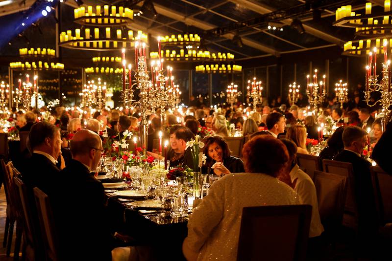 Guests dined in heated tents amid candle-style lighting on the South Lawn. Reuters