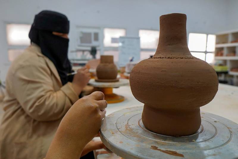 Saudi women work on pots in a workshop in Al Ula, Saudi Arabia. Reuters