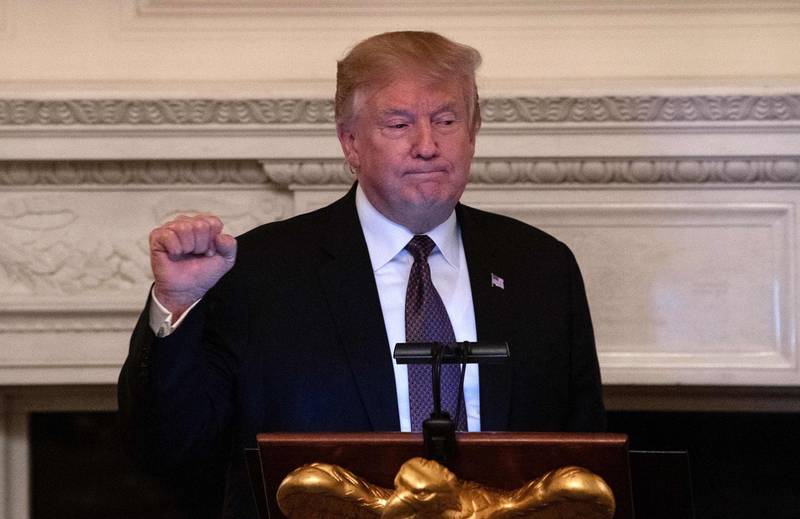 US President Donald Trump clenches his fist after speaking at an iftar, the meal that breaks the sunrise to sundown fast of Muslims celebrating Ramadan, at the White House in Washington DC on May 13, 2019. / AFP / NICHOLAS KAMM
