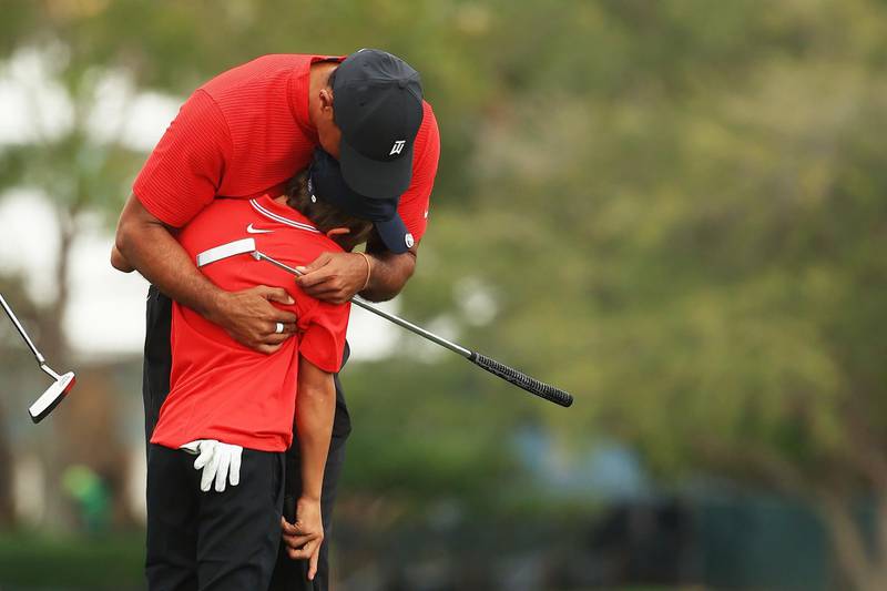 Tiger Woods and son Charlie hug during the final round of the PNC Championship at the Ritz-Carlton Golf Club. AFP