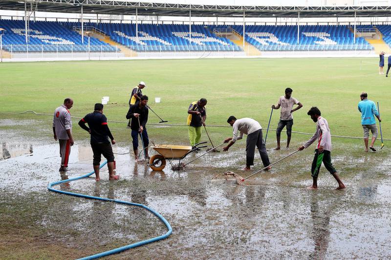 SHARJAH, UNITED ARAB EMIRATES , Dec 11– 2019 :- Ground staff clearing  the rain water from the cricket ground at the Sharjah Cricket Stadium in Sharjah. World Cup League 2 match between UAE vs Scotland abandoned due to wet ground. ( Pawan Singh / The National )  For News/Sports/Instagram/Online. Story by Paul
