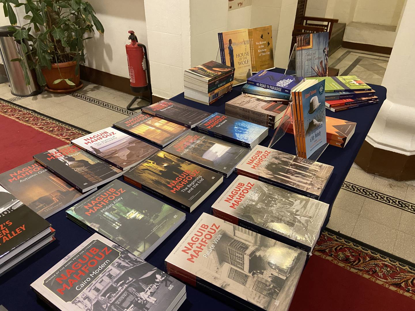 The English translations of Naguib Mahfouz books, alongside past winners of the AUC’s Naguib Mahfouz Medal for Literature. Nada El Sawy / The National