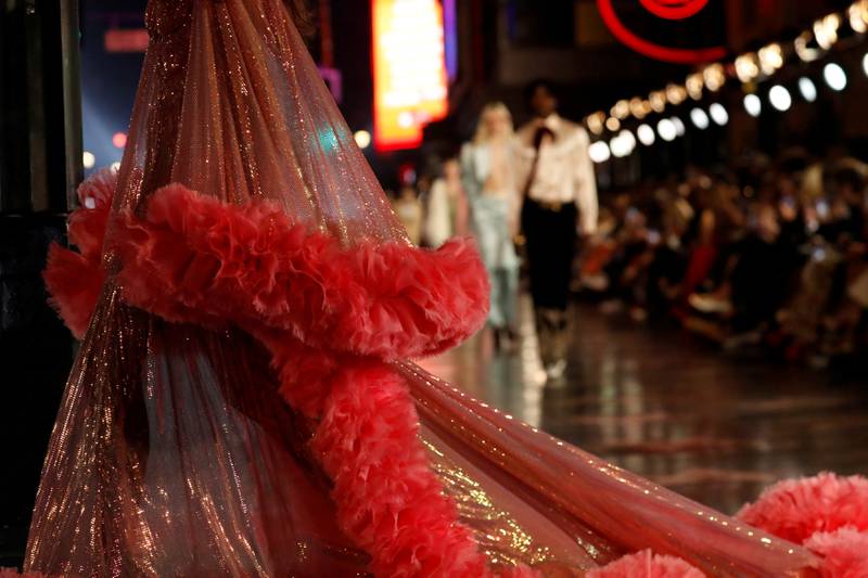 Michele brought his love for old cinematic wardrobes to life with cowboy hats, feathered gowns, faux fur coats, diamond tiaras, crop tops, wide-legged trousers and voluminous dresses. Reuters