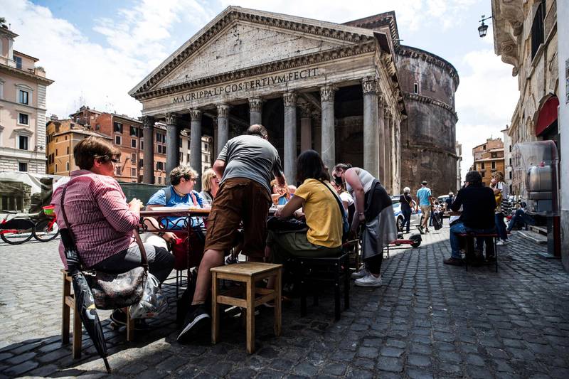 People eat outdoors at a restaurant near the Pantheon, in the centre of Rome, Italy. EPA