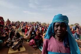 Sudanese refugees wait to receive a WFP food portion in Koufroun, Chad. Reuters