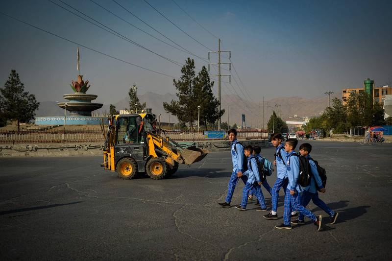 Children walk along a road in Kabul. Photo: AFP