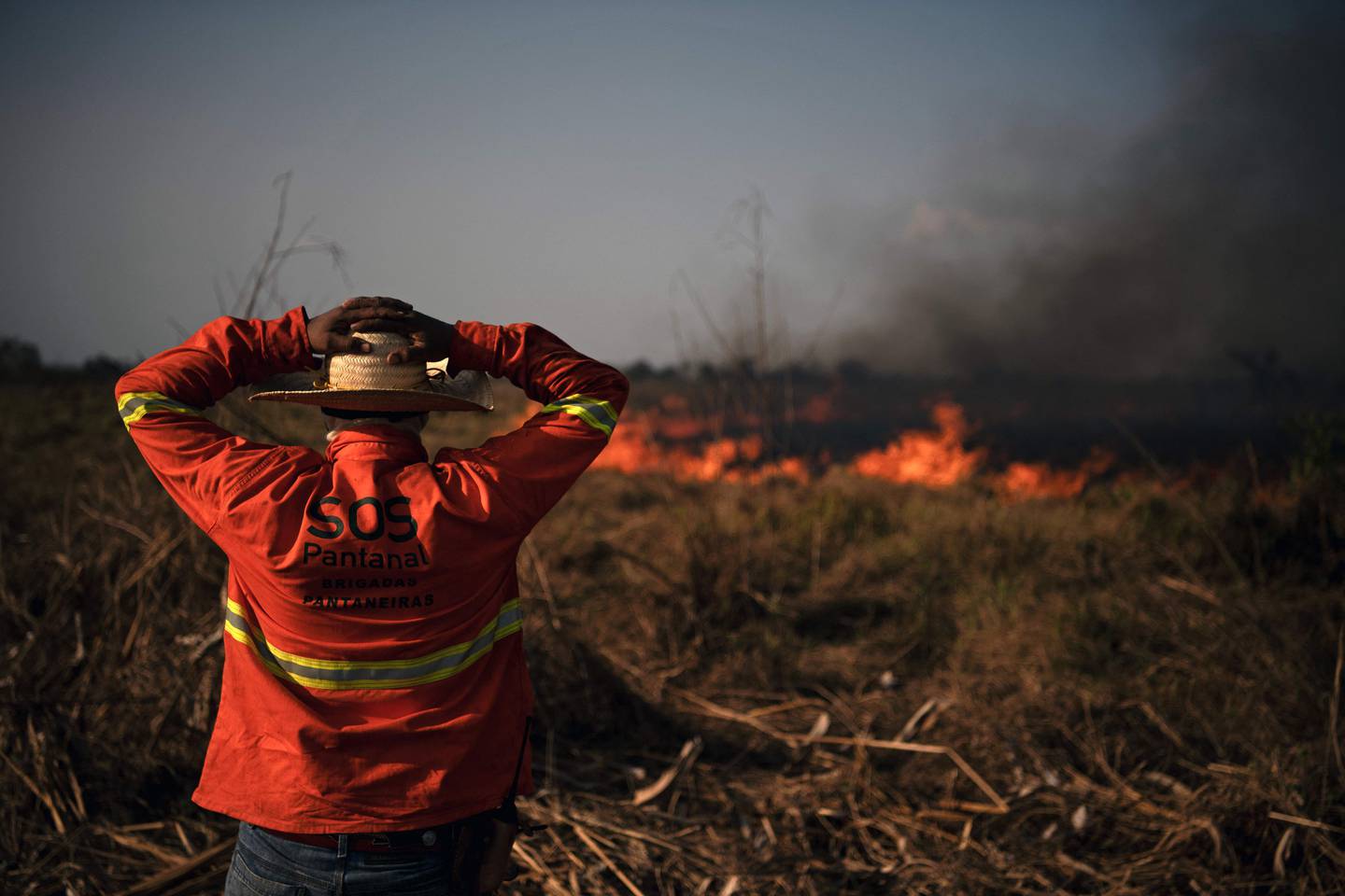 A firefighter looks at a large forest fire in Porto Jofre, Pantanal, Mato Grosso state, Brazil, on September 4, 2021.  - The Amazon, home to more than three million species, has absorbed a large amount of pollution, as carbon dioxide emissions have surged by 50 per cent in 50 years. AFP