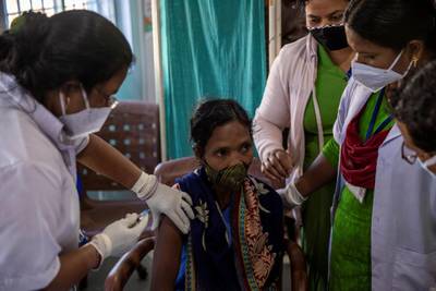 Reena Jani, 34, a health worker, receives the vaccine developed by Oxford/AstraZeneca at Mathalput Community Health Centre in Koraput, India. Reuters