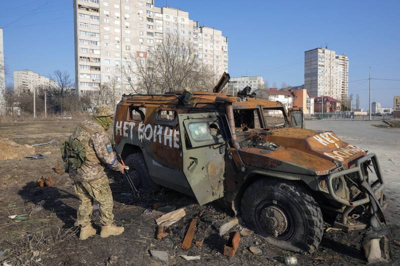 Graffiti by Ukrainian soldiers on a destroyed Russian armoured car reads: 'No to War'.  AP Photo