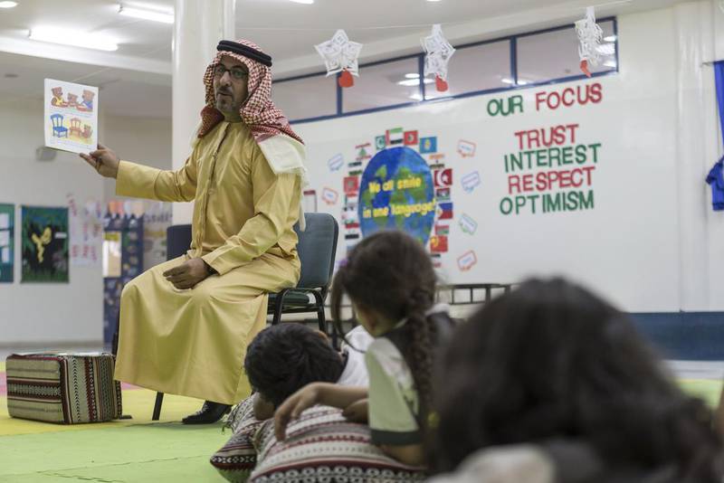 Fahad Abdelkareem Elnawaisah reads a story in his son’s class at Al Maaref Private School. Antonie Robertson / The National