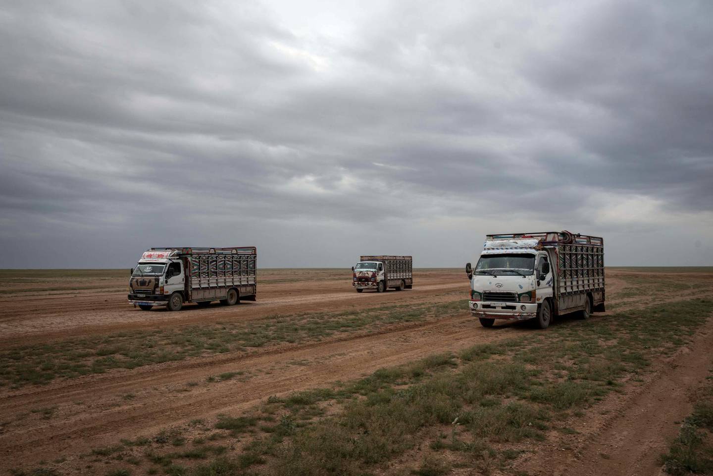 Trucks drive through the desert to pick up surrendering ISIS fighters and their supporters, outside Baghouz ,Syria, 7 March 2019.