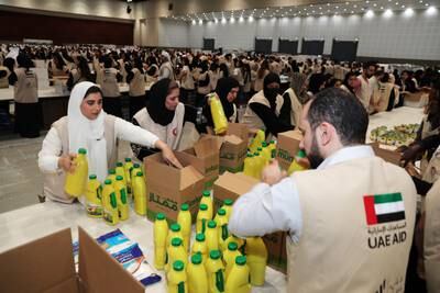 Volunteers pack essential supplies for those affected by the earthquake in Syria and Turkey at Dubai World Trade Centre. Pawan Singh / The National