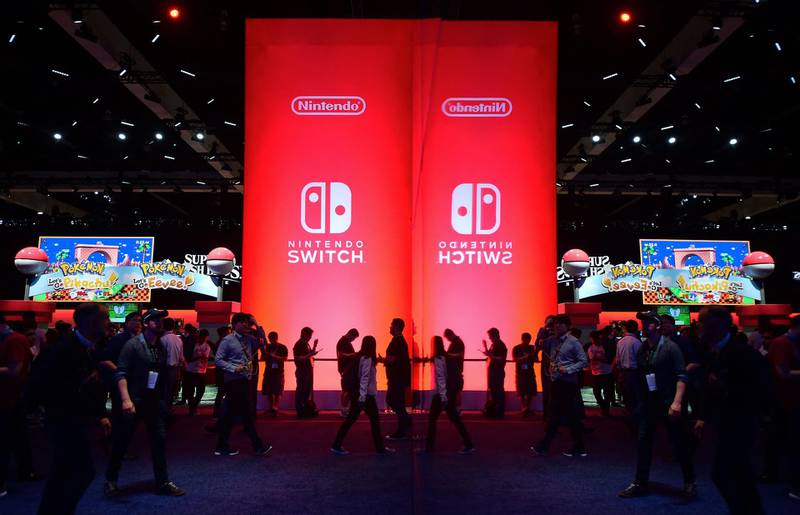 (FILES) In this file photo taken on June 12, 2018, people wait line to sample Nintendo Switch games at the 24th Electronic Expo, or E3 2018, in Los Angeles. Nintendo on June 15, 2021, unveiled updated versions of its hit console games including Zelda and Super Smash Brothers, but disappointed fans looking for a new model of its popular Switch console. / AFP / Frederic J. BROWN
