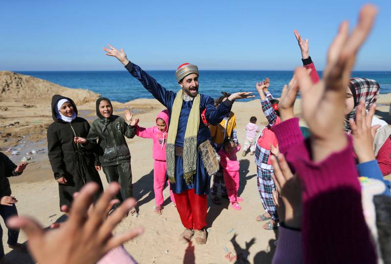 Palestinian Mohammed Al Amodi, dressed in Ali Baba costume, sings and dances to entertain children in Rafah in the southern Gaza Strip. All photos: Reuters