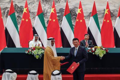 Sheikh Mohamed bin Zayed and Mr Xi witness the signing of agreements between the UAE and China on Monday. Andy Wong / AP