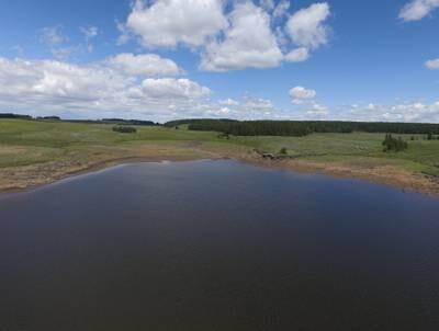 An aerial shot of a depleted reservoir on Grand Mesa outside Grand Junction, Colorado. Janie VanWinkle relies on the reservoir to feed her cattle.