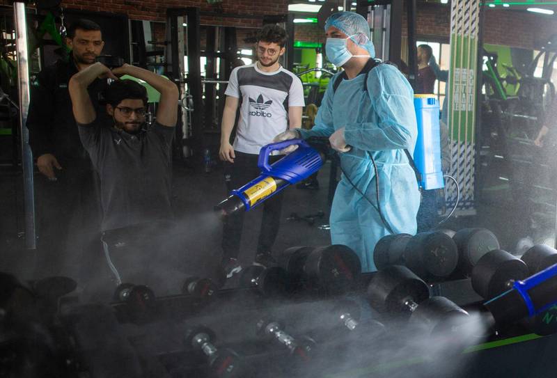 A Palestinian health worker sprays disinfectant as a precaution against the coronavirus in a gymnasium in Gaza City. AP