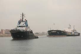 Suez Canal tugs trying to free stuck ship