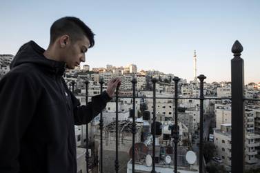 Palestinian Yehiya Derbas ,17,on the balcony of his home in Issawiyah.  Heidi Levine For The National