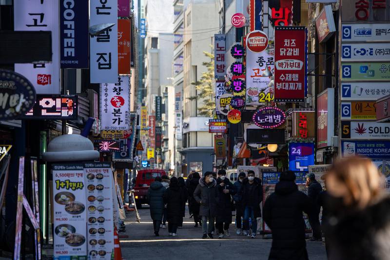 Pedestrians wearing protective masks walk through the street in the Jongno district of Seoul, South Korea. South Korea will impose a “special quarantine period” for two weeks from February 2 in the run-up to the Lunar New Year holidays to prevent another wave of infections. Bloomberg