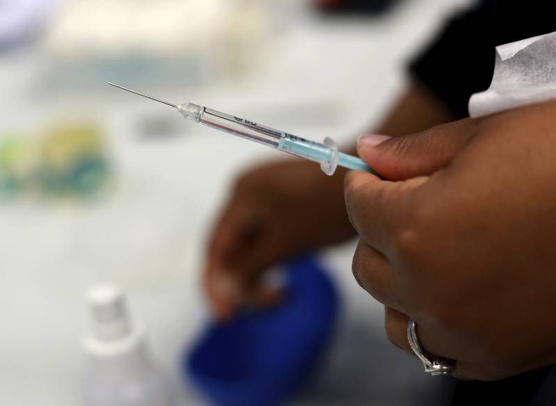 A Johnson & Johnson booster vaccine is prepared at the Vaccination Centre of Hope at the Cape Town International Convention Centre in Cape Town. AP