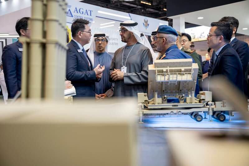 Sheikh Mohamed and Sheikh Mansour visit a booth at the event