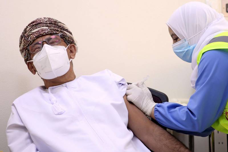 Oman's Health Minister Ahmed al-Saeedi reacts as he receives his first dose of the Pfizer-BioNTech Covid-19 vaccine, in the Omani capital Muscat.  AFP