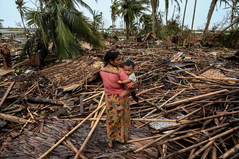 A Rohingya woman assesses the damage at Basara refugee camp in Sittwe after Cyclone Mocha rampaged through Myanmar. AFP

