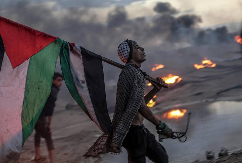 A Palestinian protester during clashes after protest near the border between Israel and the Gaza Strip. EPA