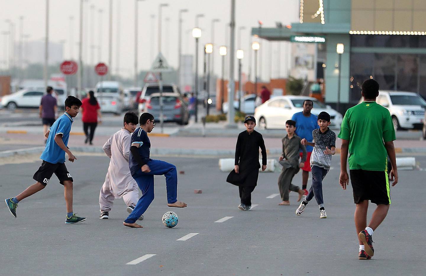 ABU DHABI , UNITED ARAB EMIRATES , JULY 24 – 2018 :- Kids playing football during the evening in Mussafah area in Abu Dhabi.  ( Pawan Singh / The National )  For News. Story by John