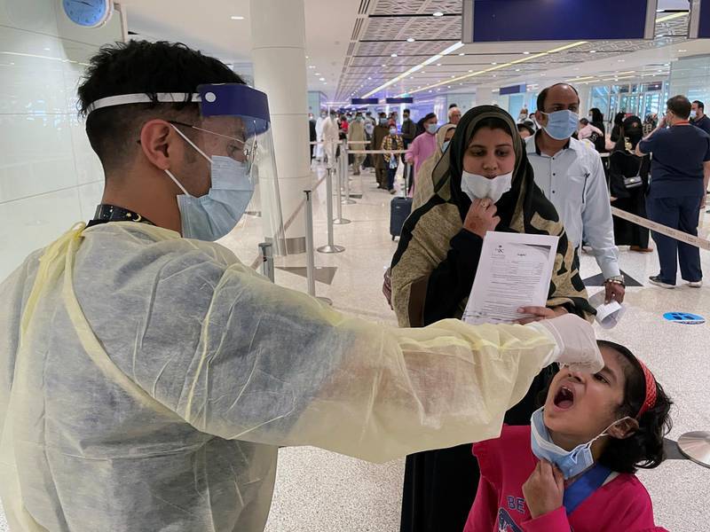 Saudi medical staff give oral medication to the first batch of Muslims from international flights on their way to perform Umrah. Reuters