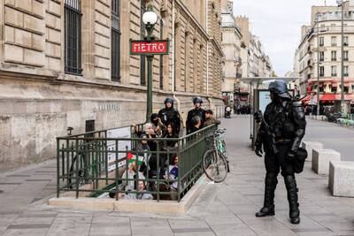 Riot police guard a subway station in Paris as demonstrators shout pro-Palestinian slogans. EPA