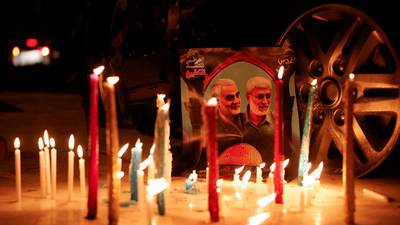 Candles are placed next to a picture of Iranian military commander Qassem Suleimani and Iraqi militia leader Abu Mahdi Al Muhandis, at Baghdad Airport in Iraq on Sunday, before events to mark the second anniversary of their killing. Reuters