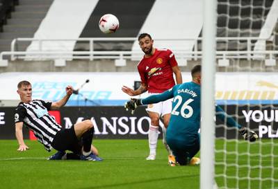 Manchester United's Portuguese midfielder Bruno Fernandes (C) scores their second goal during the English Premier League football match between Newcastle United and Manchester United at St James' Park in Newcastle-upon-Tyne, north east England on October 17, 2020. RESTRICTED TO EDITORIAL USE. No use with unauthorized audio, video, data, fixture lists, club/league logos or 'live' services. Online in-match use limited to 120 images. An additional 40 images may be used in extra time. No video emulation. Social media in-match use limited to 120 images. An additional 40 images may be used in extra time. No use in betting publications, games or single club/league/player publications.
 / AFP / POOL / Alex Pantling / RESTRICTED TO EDITORIAL USE. No use with unauthorized audio, video, data, fixture lists, club/league logos or 'live' services. Online in-match use limited to 120 images. An additional 40 images may be used in extra time. No video emulation. Social media in-match use limited to 120 images. An additional 40 images may be used in extra time. No use in betting publications, games or single club/league/player publications.

