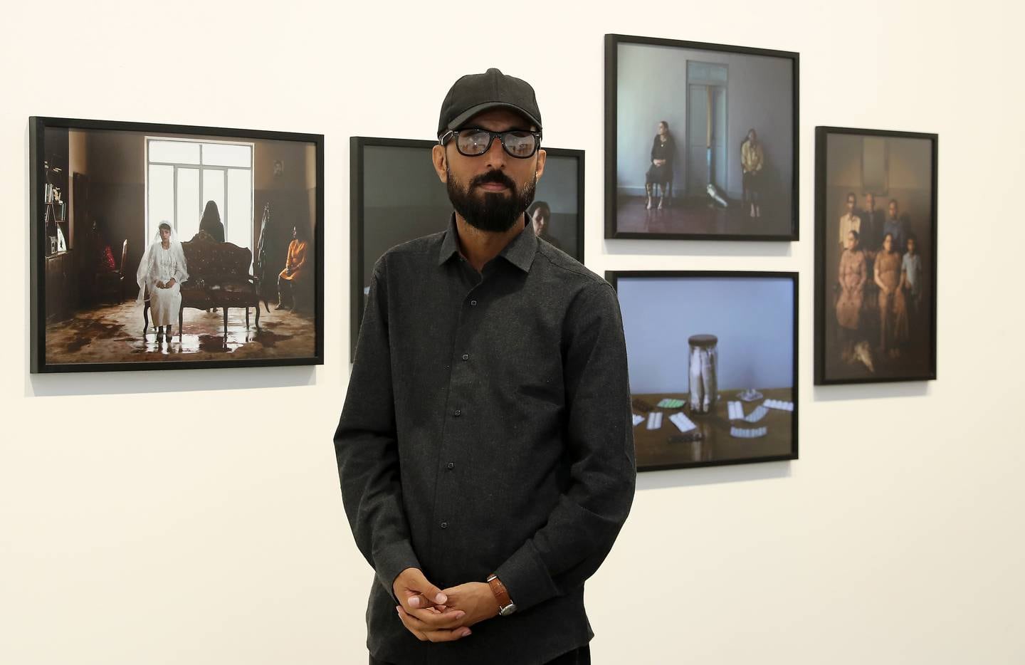 Morteza Niknahad with his 'Big Fish' photographs, which are on display as part of the Vantage Point Sharjah exhibition. Pawan Singh / The National