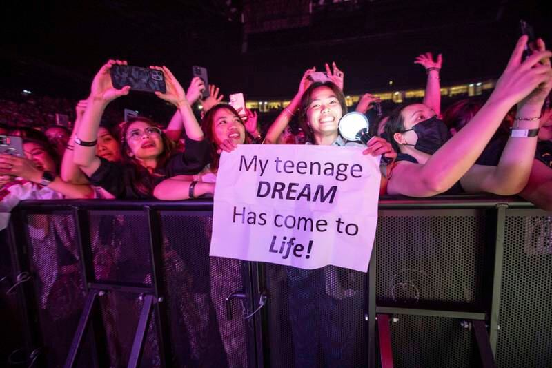 A fan holds up a sign saying her 'teenage dream' has come true. 