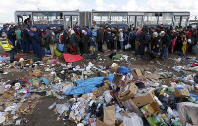 Migrants wait to board a bus at a migrant collection point in Roszke, Hungary. Laszlo Balogh / Reuters