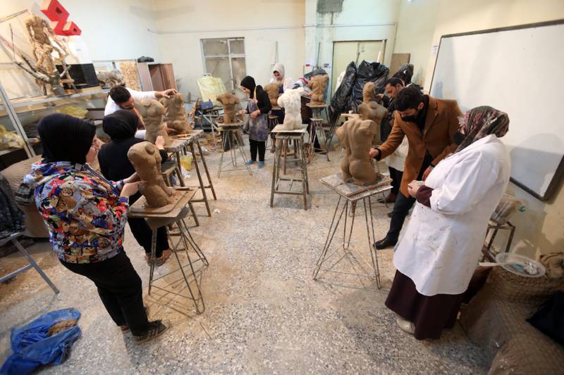 Iraqi students during a sculpture class at the college, a faculty of the University of Baghdad.