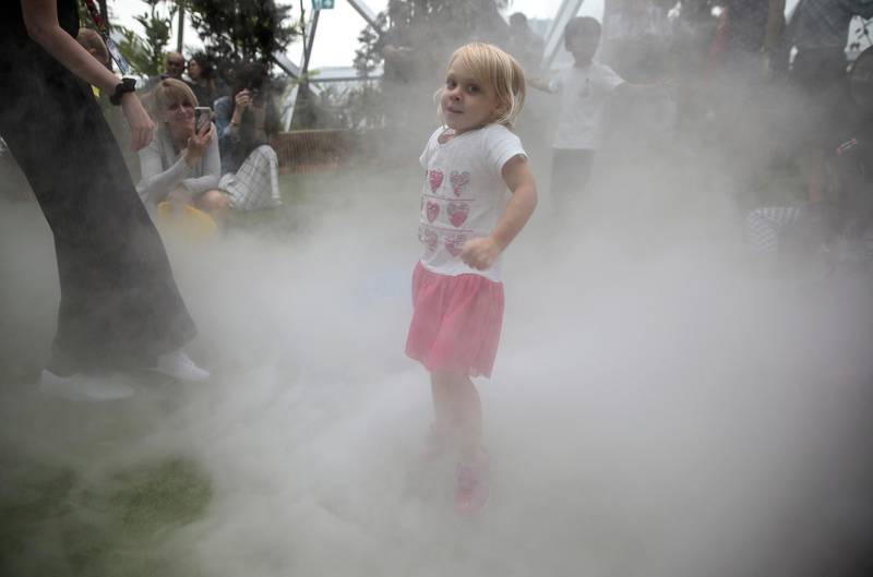A young girl reacts as she jumps in the Foggy Bowl attraction.  EPA