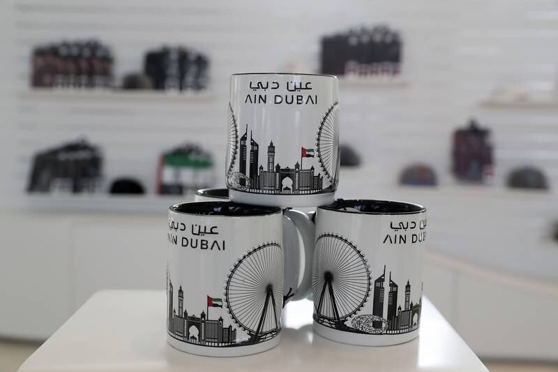 Mugs, T-shirts, pens and keychains can be found at the Ain Dubai gift shop. Pawan Singh / The National