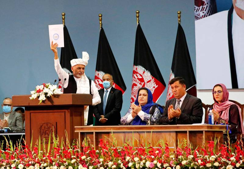 Afghan President Ashraf Ghani holds up the resolution on the last day of a loya jirga or traditional council, in Kabul. AP Photo