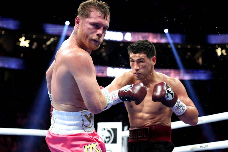Dmitry Bivol punches Canelo Alvarez during their WBA light heavyweight title fight at T-Mobile Arena.
