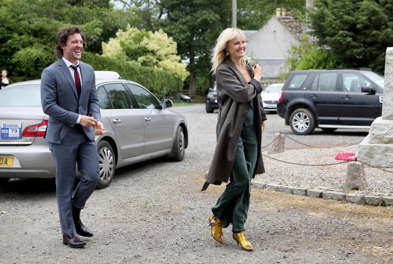 Actor Jack Donnelly arrives with partner Malin Akerman for the wedding ceremony of Game Of Thrones actors Kit Harington and Rose Leslie.  Jane Barlow / PA via AP