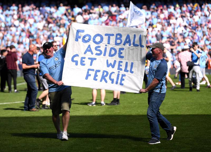 Two Manchester City fans hold up a banner for Alex Fergurson after the Premier League match between Manchester City and Huddersfield Town at Etihad Stadium in Manchester, England, on May 6, 2018. Laurence Griffiths / Getty Images