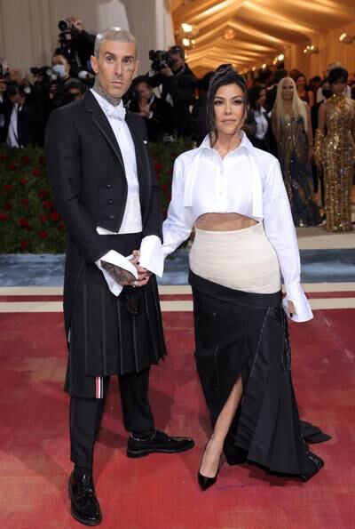 Kourtney Kardashian and Travis Barker, both wearing Thom Browne. Reuters 